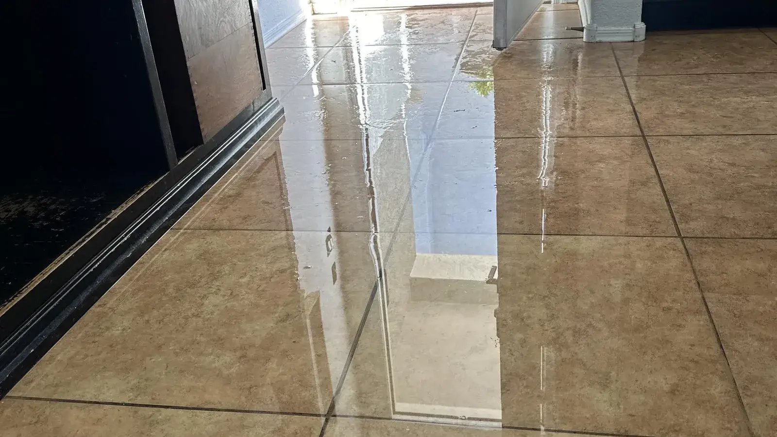 Standing water on a tile floor in a Mesa home — Fast Track Restoration job photo