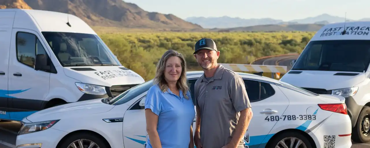 Becci Stoflet and Brian Bradford, co-founders of Mesa-based Fast Track Restoration, with the company car and vans
