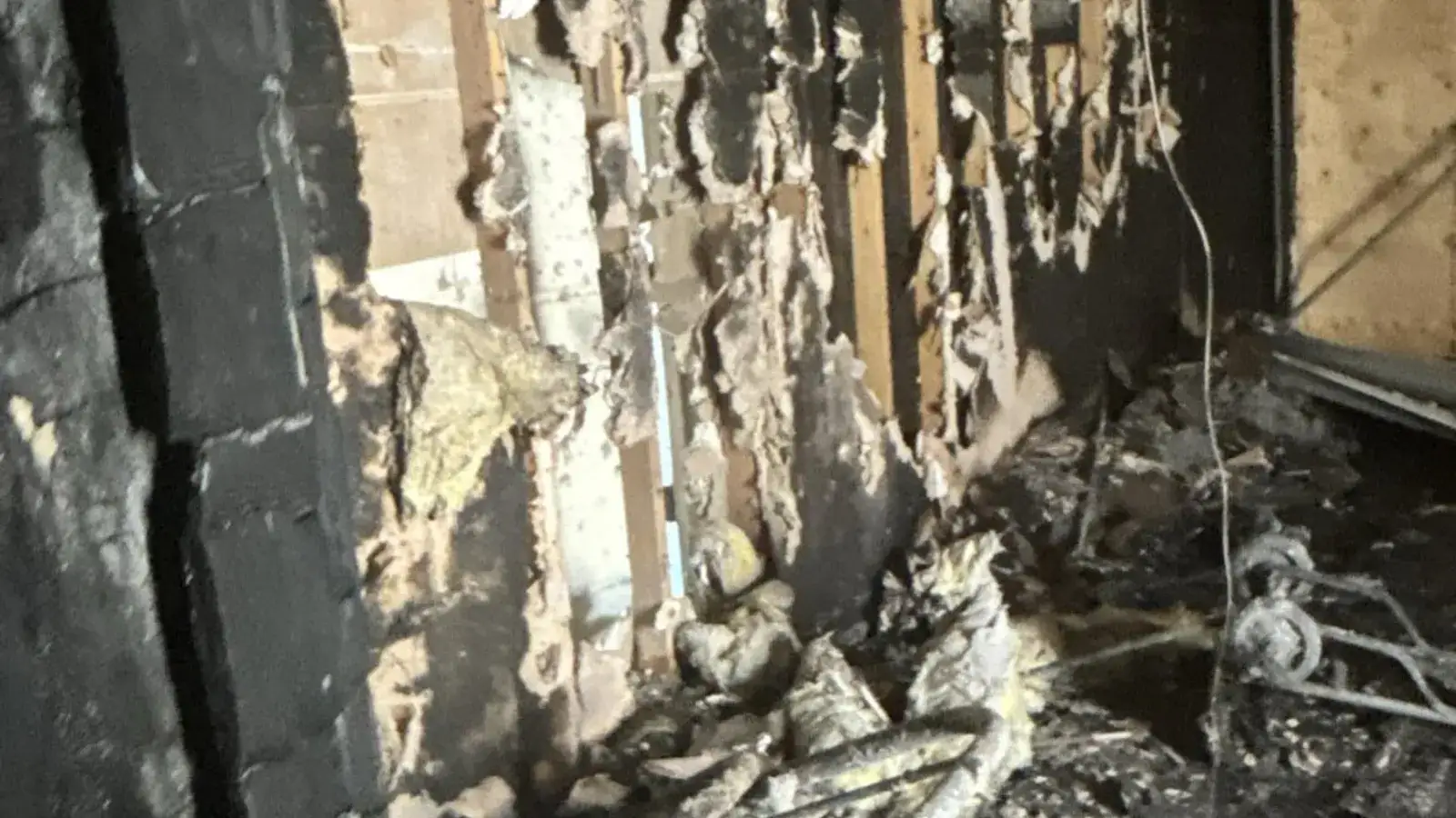Charred wall framing after a house fire — Fast Track Restoration job photo