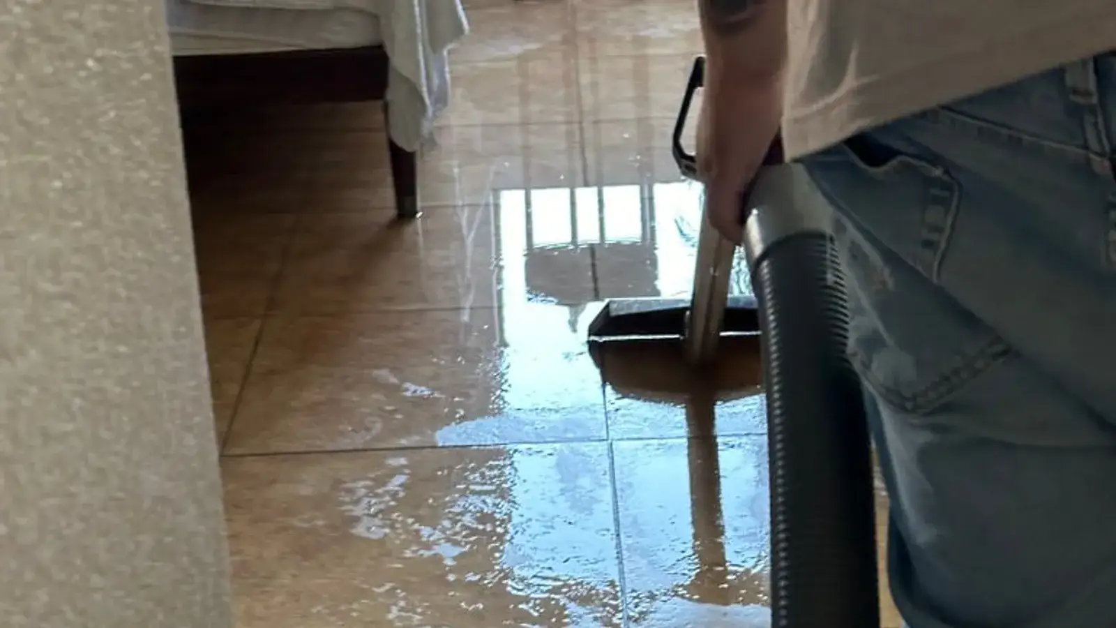 Extracting standing water from a tile floor — Fast Track Restoration