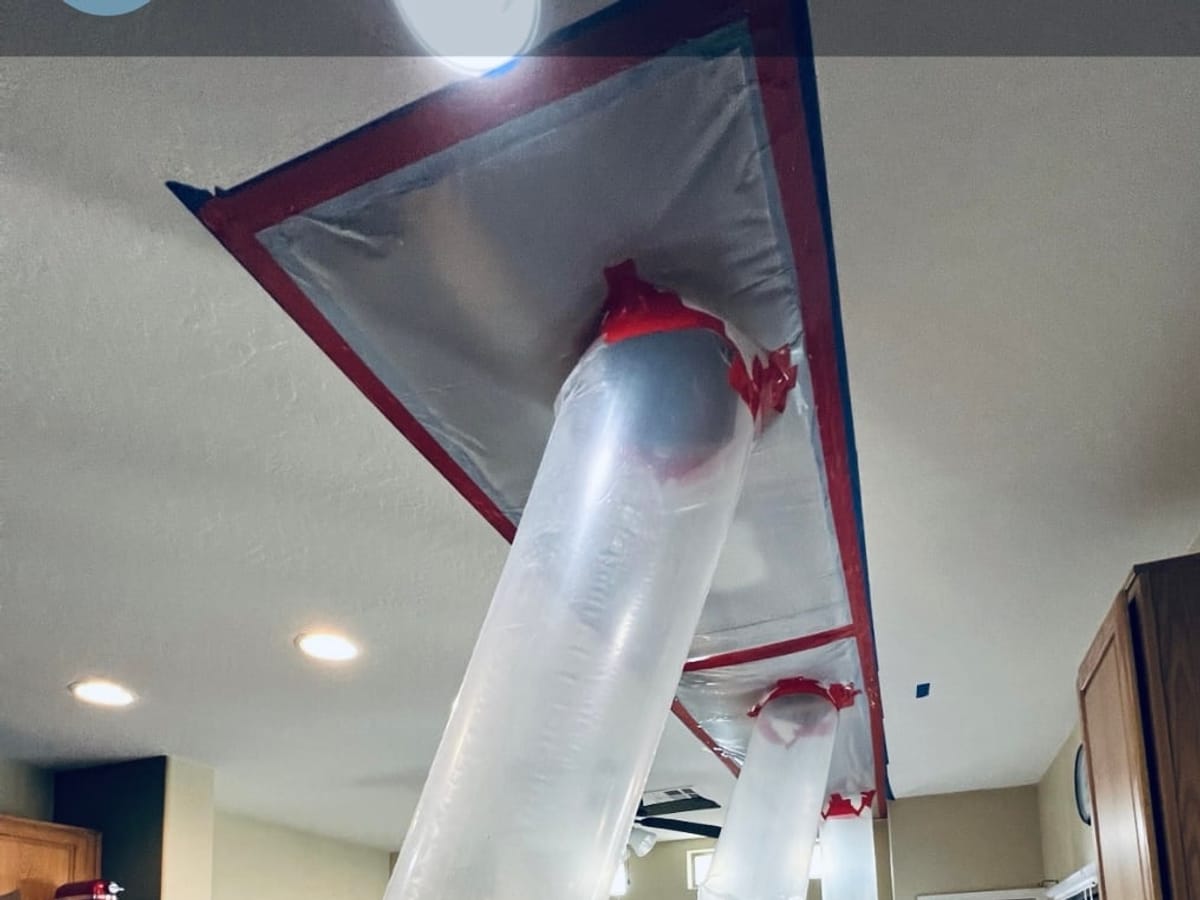 Drying ducts and containment set up to dry a water-damaged ceiling