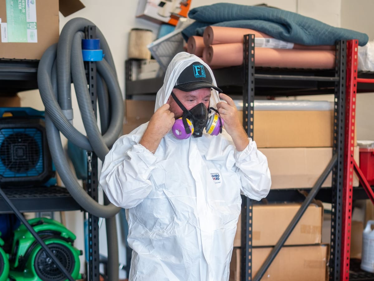Fast Track technician suiting up in protective equipment for mold remediation